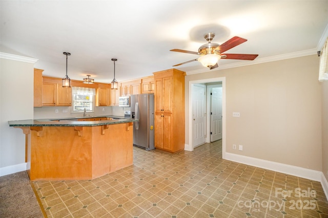 kitchen featuring a peninsula, a kitchen bar, stainless steel appliances, and crown molding