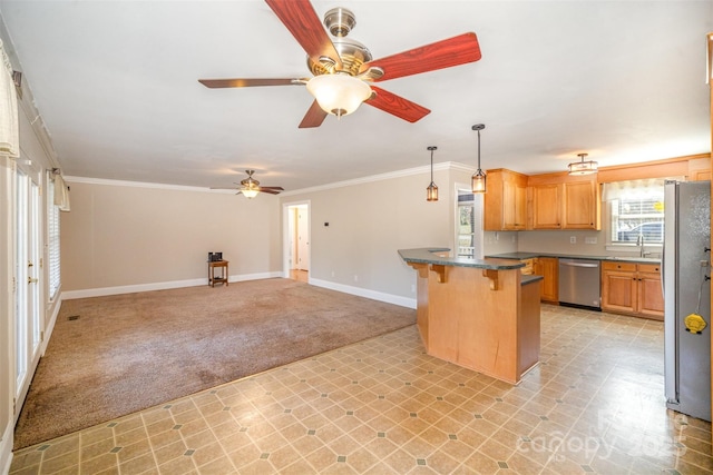 kitchen featuring light colored carpet, stainless steel appliances, a breakfast bar, baseboards, and ornamental molding