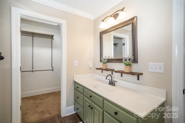 bathroom with crown molding, vanity, and baseboards