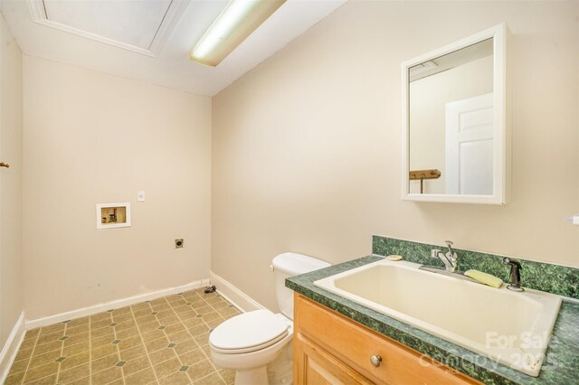 bathroom with vanity, toilet, and baseboards