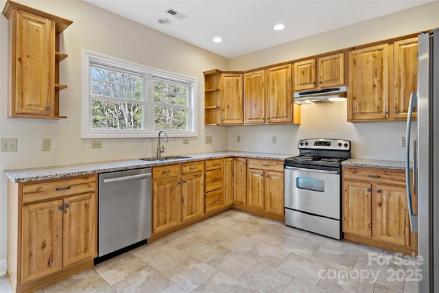 kitchen with appliances with stainless steel finishes, light stone countertops, under cabinet range hood, open shelves, and a sink