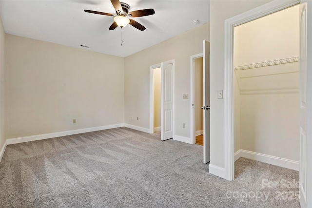 unfurnished bedroom with a ceiling fan, light colored carpet, visible vents, and baseboards