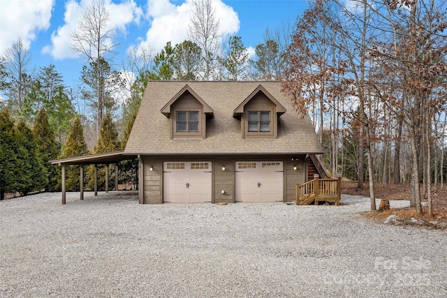 exterior space featuring a garage, a shingled roof, driveway, stairway, and a carport