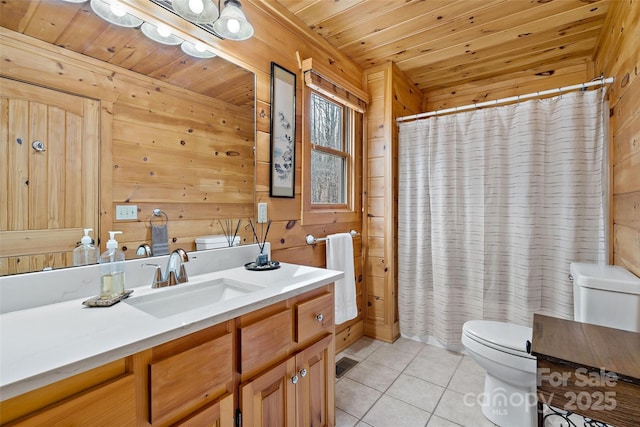 bathroom featuring vanity, tile patterned floors, wood ceiling, and wooden walls