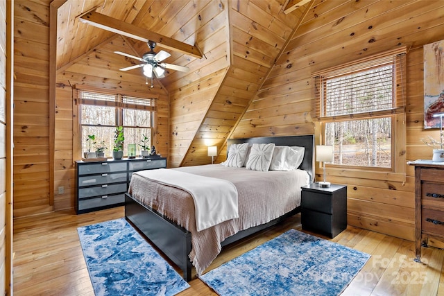 bedroom featuring vaulted ceiling, wooden ceiling, wood finished floors, and wooden walls