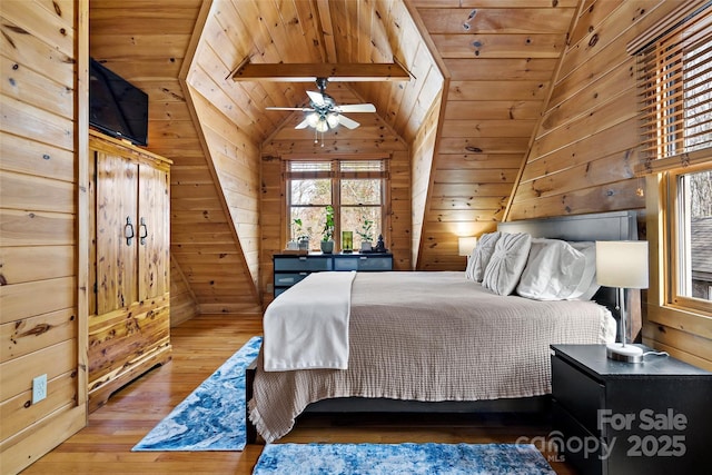 bedroom featuring lofted ceiling with beams, wooden ceiling, wood finished floors, and wooden walls