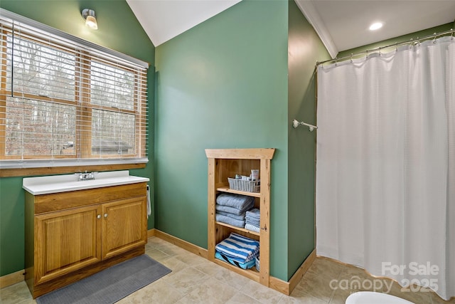 full bathroom featuring baseboards, tile patterned floors, curtained shower, vaulted ceiling, and vanity