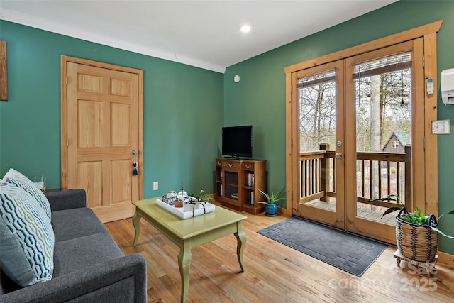 living room featuring french doors and light wood-style flooring