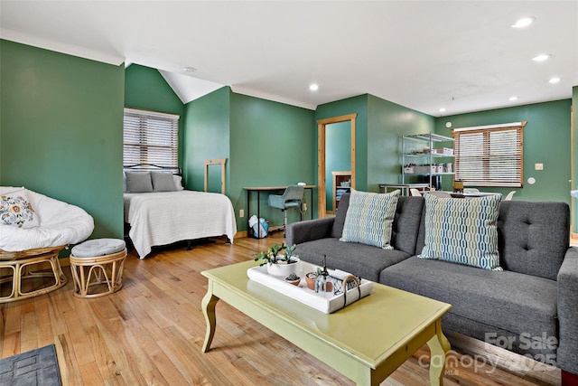 living room with baseboards, light wood finished floors, recessed lighting, and a healthy amount of sunlight