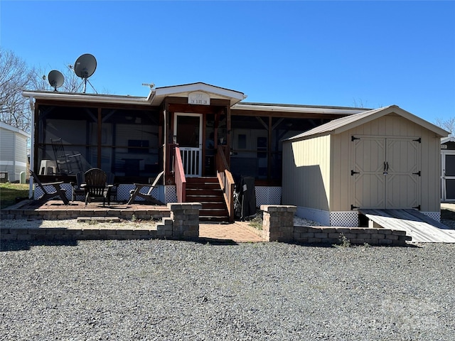 view of front facade featuring a storage shed and an outbuilding