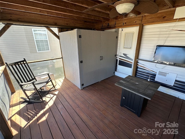 wooden terrace featuring a ceiling fan