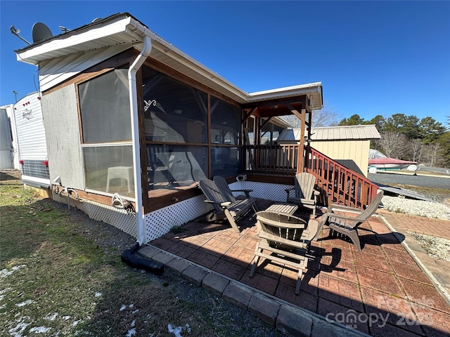 exterior space with a sunroom and a patio area