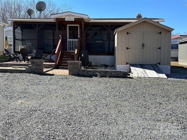 view of front of home with a shed and an outbuilding