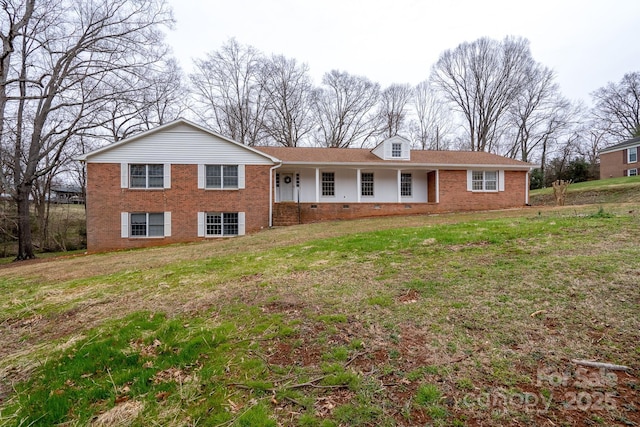 view of front of home with a front lawn, a porch, brick siding, and crawl space