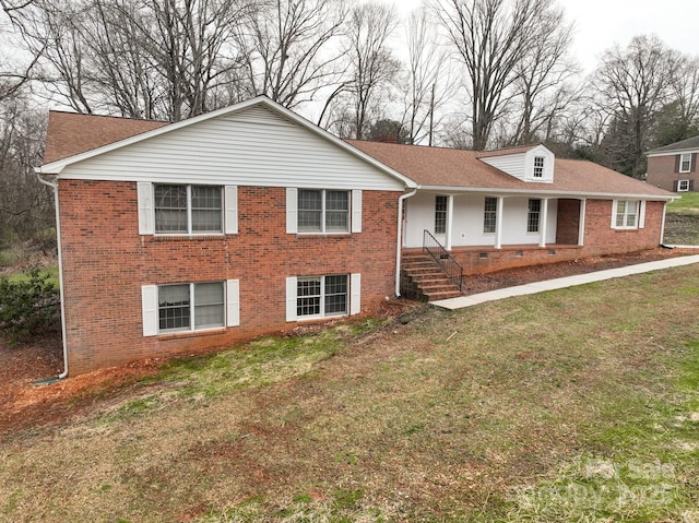 view of front of property featuring brick siding, a porch, and a front yard