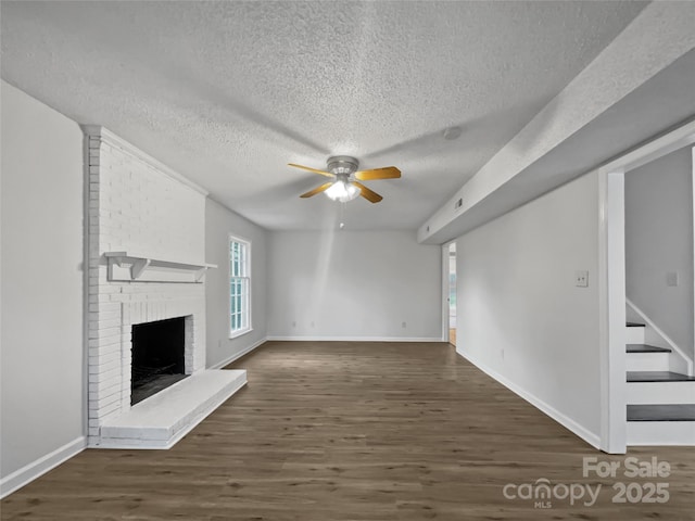 unfurnished living room featuring ceiling fan, a fireplace, baseboards, stairway, and dark wood finished floors