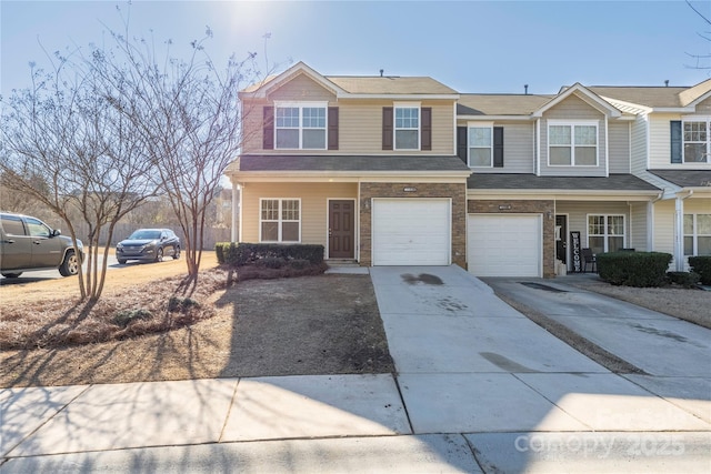 view of property featuring a garage and driveway