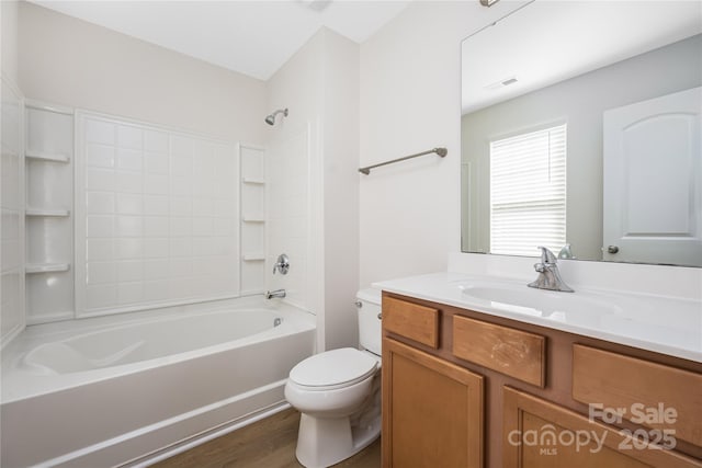 full bath featuring shower / bath combination, visible vents, toilet, wood finished floors, and vanity