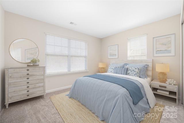 bedroom with carpet floors, visible vents, and baseboards