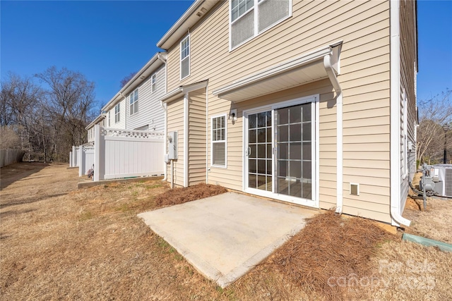 back of property with cooling unit, a patio area, and fence