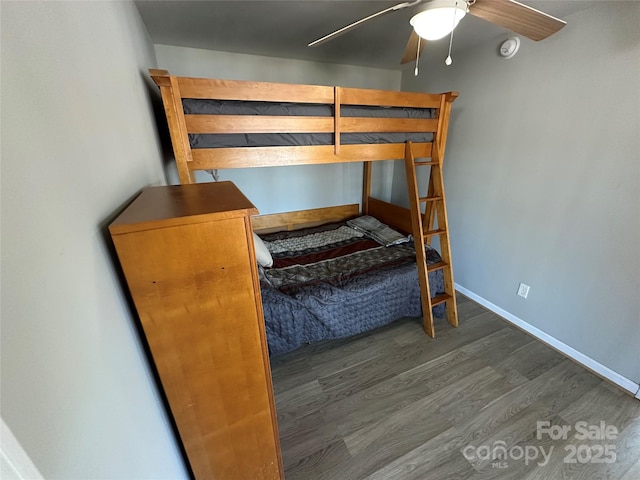 117 Badin Lake Cir, New London, NC 28127 - unfurnished bedroom featuring a ceiling fan, baseboards, and dark wood-style flooring