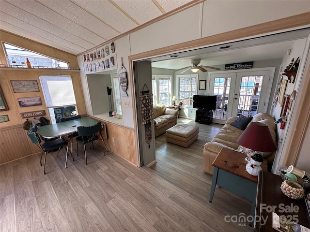 117 Badin Lake Cir, New London, NC 28127 - interior space featuring wooden walls, wainscoting, wood finished floors, vaulted ceiling, and french doors