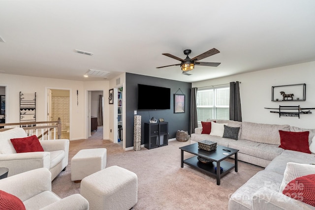 living room with light carpet, ceiling fan, visible vents, and baseboards