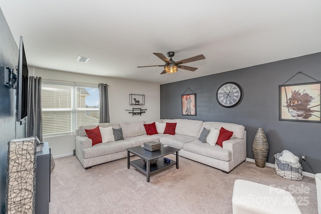 living room featuring light carpet, baseboards, visible vents, and ceiling fan