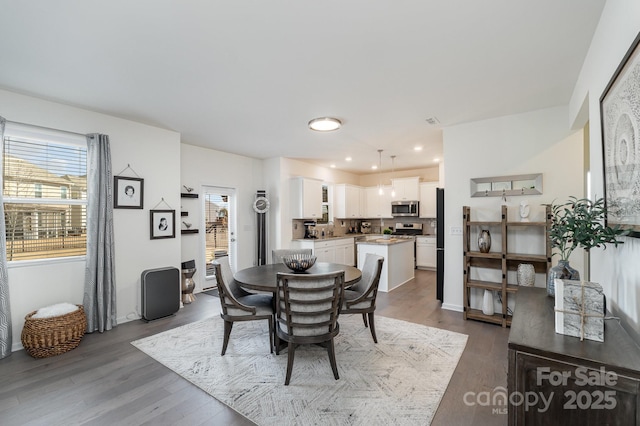 dining space featuring recessed lighting and dark wood finished floors