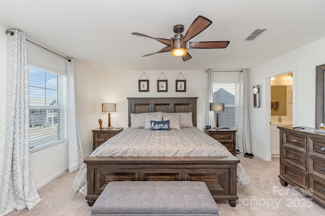 bedroom with light carpet, multiple windows, visible vents, and baseboards