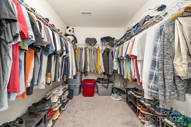 spacious closet featuring carpet flooring and visible vents