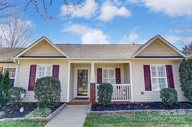 view of front of house with covered porch and a shingled roof