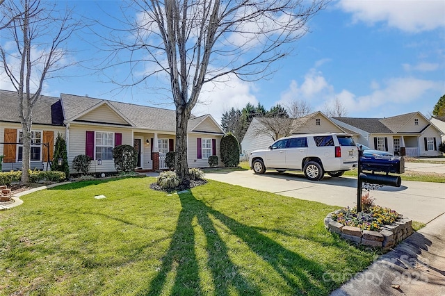 view of yard with concrete driveway