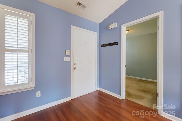 foyer entrance featuring wood finished floors, visible vents, and baseboards