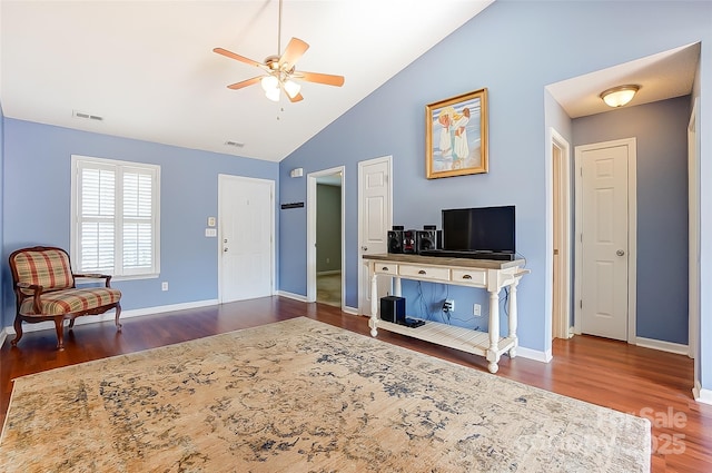 living area featuring a ceiling fan, visible vents, and wood finished floors