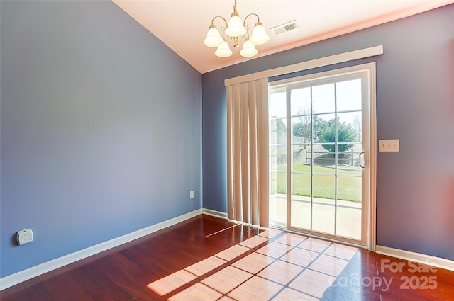 interior space with wood finished floors, visible vents, and baseboards