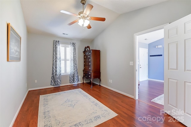 bedroom featuring vaulted ceiling, baseboards, and wood finished floors