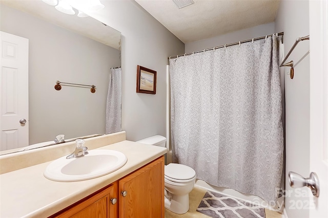 bathroom featuring a textured ceiling, visible vents, vanity, and toilet