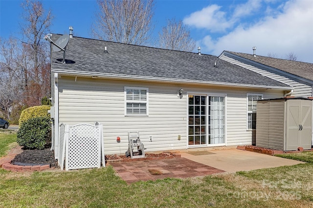 back of property with an outbuilding, a patio area, a lawn, and a shed