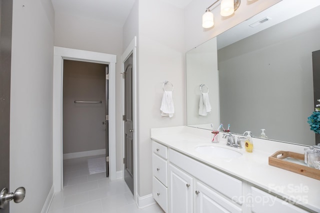 bathroom featuring visible vents, vanity, baseboards, and tile patterned floors