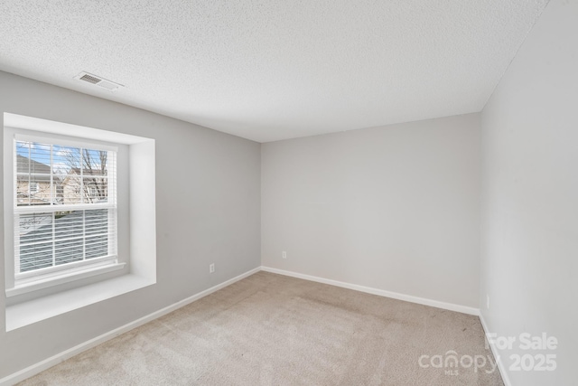 unfurnished room featuring light carpet, baseboards, and visible vents