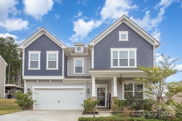 craftsman inspired home with a garage and driveway