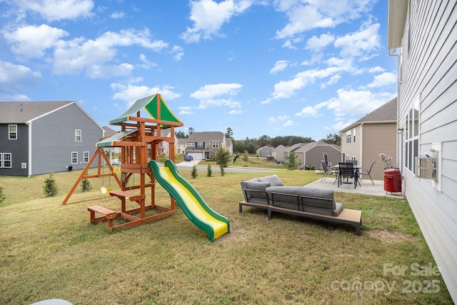 view of play area featuring a residential view, a yard, and a patio