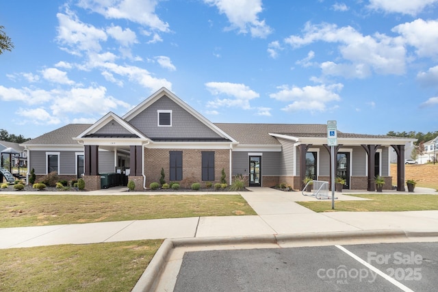 view of front of house with brick siding and a front yard