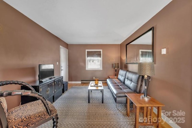 living area with baseboard heating and wood finished floors