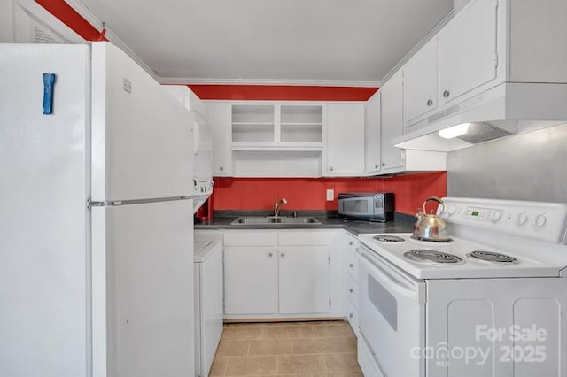 kitchen with white appliances, dark countertops, a sink, and white cabinets