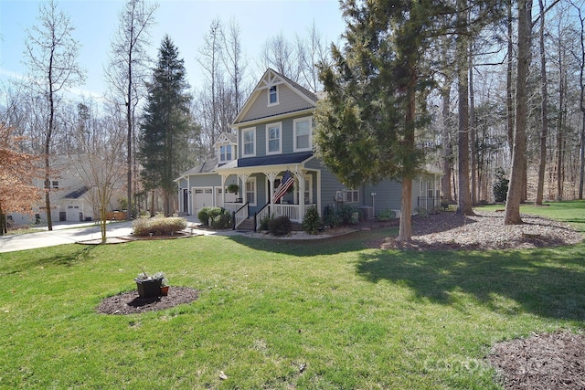 view of front of house with a porch, a front yard, and driveway