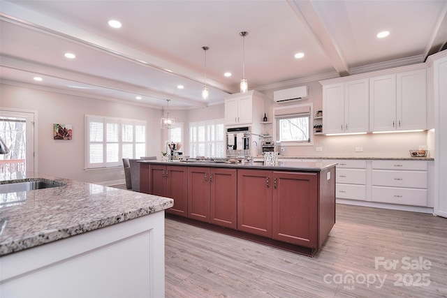 kitchen featuring a wealth of natural light, beam ceiling, open shelves, and a sink