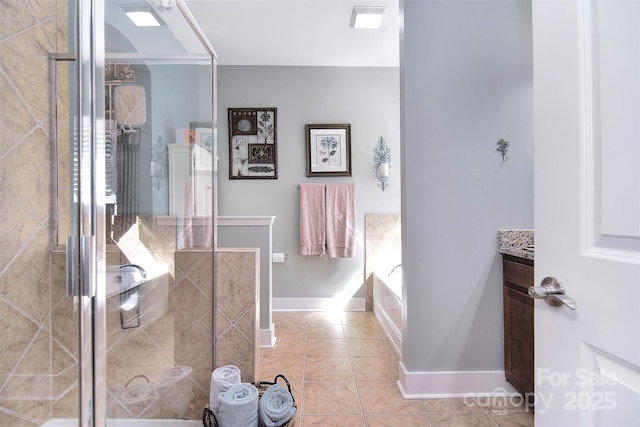 full bath with tile patterned flooring, a garden tub, a shower stall, and baseboards