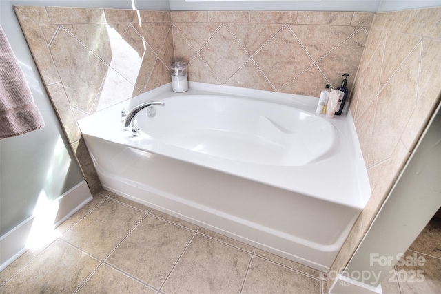 full bathroom featuring a bath and tile patterned floors